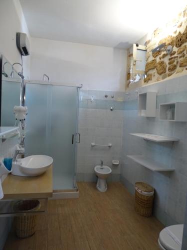 een badkamer met een douche, een toilet en een wastafel bij B&B Vinci in Noto