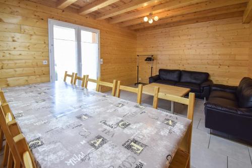 a dining room with a table and a couch at Domaine Du Sauveur in Luz-Saint-Sauveur