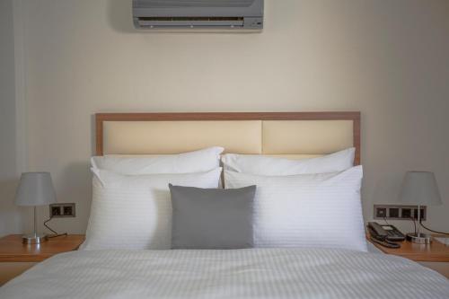 a bedroom with a bed with white pillows at Kutlucan Oldtown in Bursa