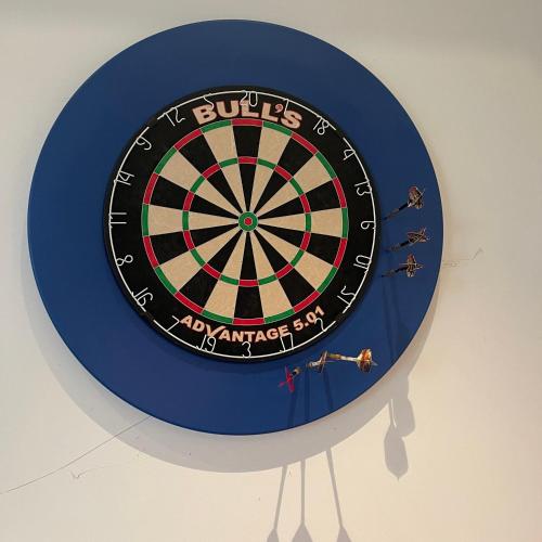 a cake with a dart board on a wall at Fögruvellir Country House in Hella