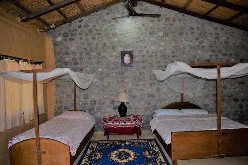 Ένα ή περισσότερα κρεβάτια σε δωμάτιο στο Mango Tree Lodge