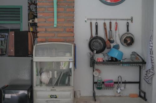 a corner of a kitchen with a counter with utensils at Abrakadabra 747 in Timuran