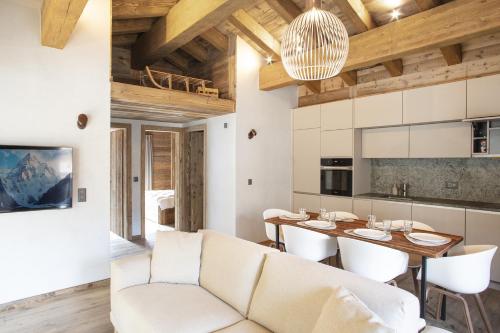 a living room and dining room with a couch and a table at Polaris 1 006 - LUXE & SKI LIFT apartment 6 pers in Zinal