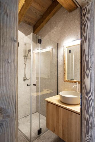 a bathroom with a glass shower and a sink at Polaris 1 006 - LUXE & SKI LIFT apartment 6 pers in Zinal