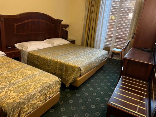 Säng eller sängar i ett rum på Hotel Valganna