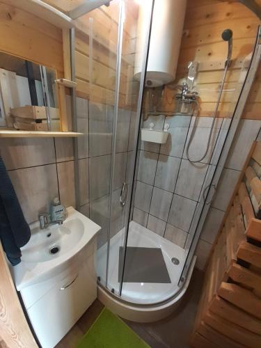 a bathroom with a shower and a toilet and a sink at cichy zakątek in Zawoja