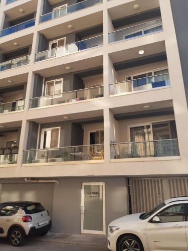two cars parked in front of a building at Bright and beautifully furnished apartment close to seafront BFRA1-2 in Il-Gżira