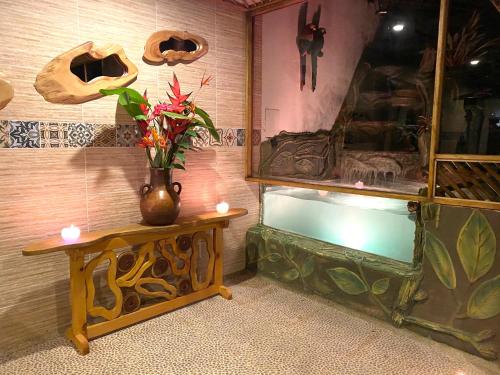 a vase sitting on a table next to a fish tank at Rancho Ecoturistico el Faro in La Mesa