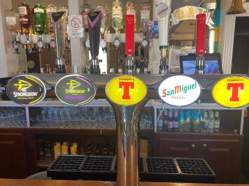 a bar with signs on the front of a bar at Queensberry arms hotel in Kirkconnel