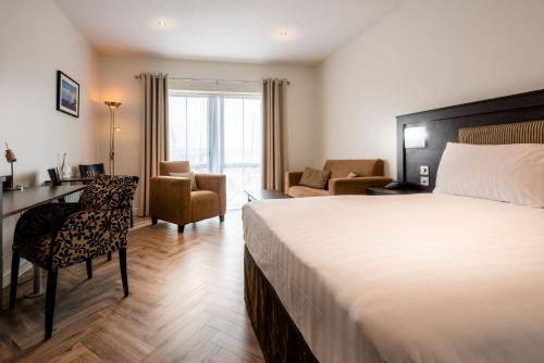 a hotel room with a bed and a desk and chair at Da Vinci's Hotel in Derry Londonderry