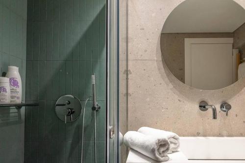 a bathroom with a shower and a mirror at Electra Luxury Apartment at the Heraklion Center in Heraklio