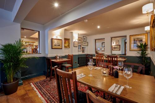a restaurant with a wooden table and chairs at The Ship in Parkgate