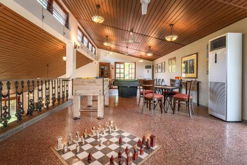 a room with a chessboard in the middle of a room at Saffronstays Casa Del Palms, Alibaug - luxury pool villa with chic interiors, alfresco dining and island bar in Alibaug