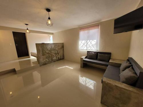 a living room with a couch and a window at D-07 NOVAGA DOWNTOWN CANCUN in Cancún