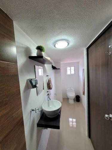 a bathroom with a sink and a toilet at D-07 NOVAGA DOWNTOWN CANCUN in Cancún