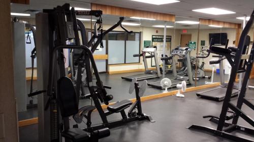 a gym with several treadmills and elliptical machines at Douglas Fir Resort & Chalets in Banff