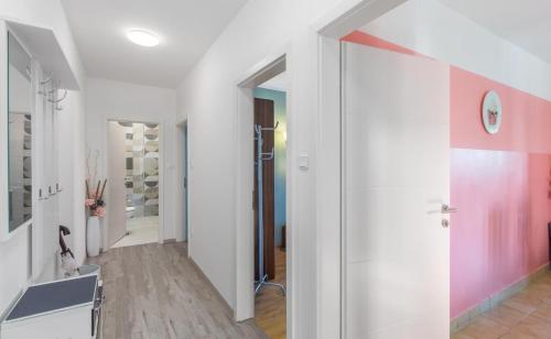 a hallway with white walls and a pink wall at Spacious new app for 5 persons, close beach&city in Poreč