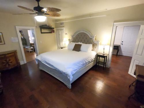 a bedroom with a white bed and a ceiling fan at Villa Mulvey #1 in Saint Augustine