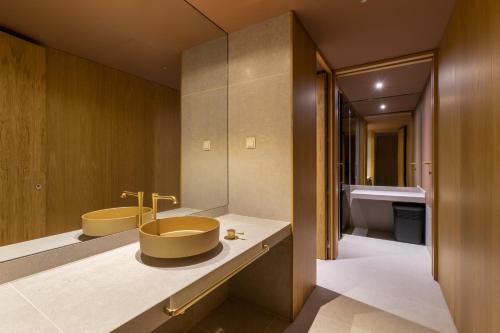 
a bathroom with a sink and a bathtub at Royal Savoy - Ocean Resort - Savoy Signature in Funchal
