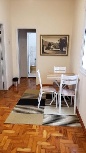 a dining room with a table and two chairs at Hotel Centenario Itajuba in Itajubá