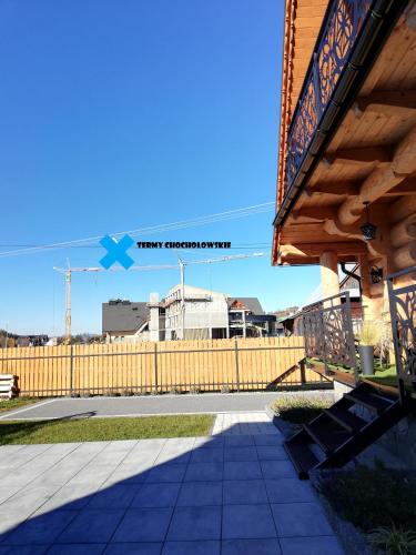 a wooden fence in front of a building at Eco Domki Podhalanka in Witów