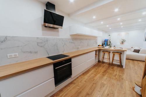 une cuisine avec des armoires blanches et un comptoir dans l'établissement Perfect family-oriented and renovated townhouse in the old Antibes, à Antibes