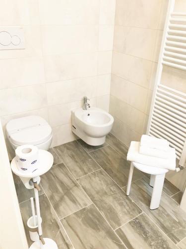 a bathroom with a toilet and a sink at Hotel Volterra In Superior in Volterra