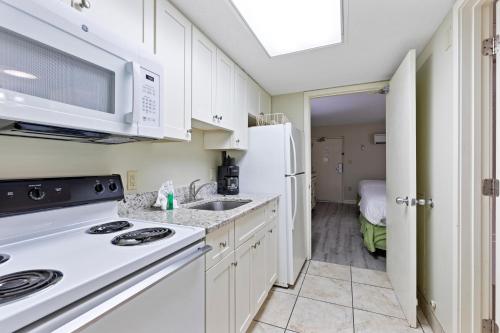 a kitchen with a sink and a microwave at Sandy Beach Resort in Myrtle Beach