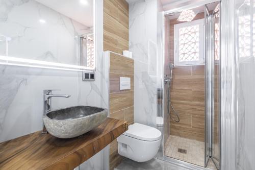 a bathroom with a stone sink and a toilet at Veracruz 20-E in Benidorm