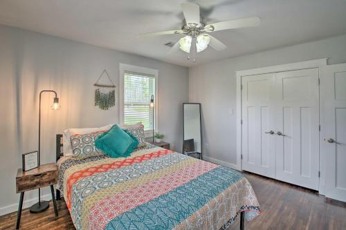 a bedroom with a bed and a ceiling fan at Cozy Hideaway By Lake Ouachita and Hot Springs! in Hot Springs Village