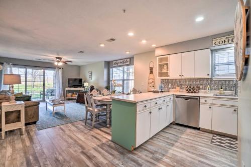a kitchen with white cabinets and a living room at Family-Friendly Condo about 3 Mi to Branson Landing in Branson