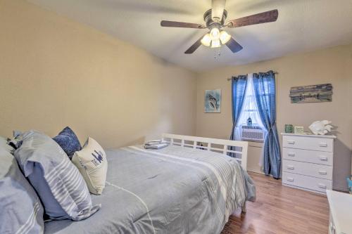 a bedroom with a bed with a ceiling fan at Cozy BeachandFishing Cottage in Aransas Pass! in Aransas Pass