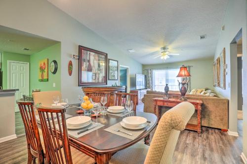 a kitchen and dining room with a table and chairs at Cheery Condo with Community Pool and Waterslide! in Pine Bluff