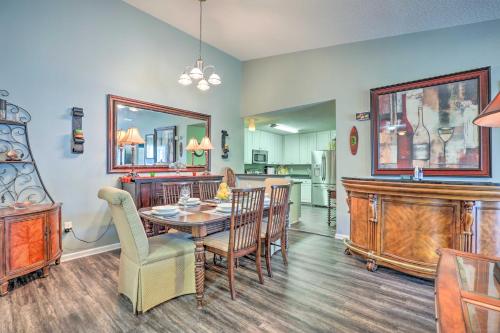 a kitchen and dining room with a table and chairs at Cheery Condo with Community Pool and Waterslide! in Pine Bluff