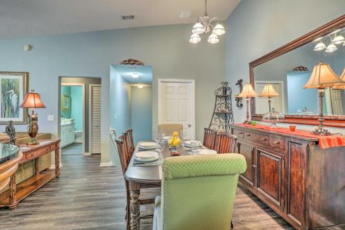 a dining room with a table and a mirror at Cheery Condo with Community Pool and Waterslide! in Pine Bluff