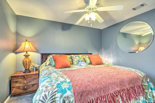 a bedroom with a bed and a ceiling fan at Cheery Condo with Community Pool and Waterslide! in Pine Bluff