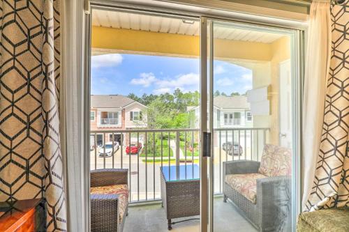 a screened porch with a view of a house at Cheery Condo with Community Pool and Waterslide! in Pine Bluff