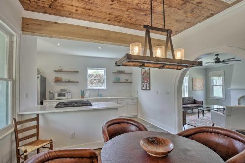 a kitchen and dining room with a table and chairs at Historic Home with Yard Near St Marys Strip! in San Antonio