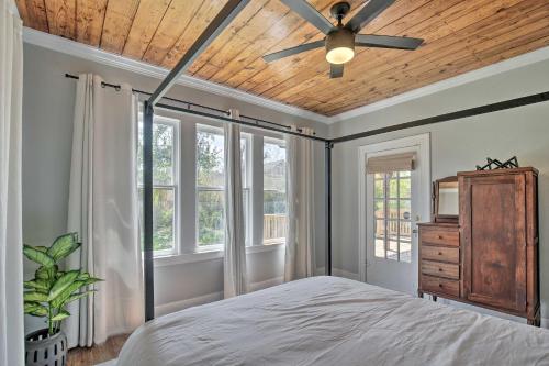 a bedroom with a ceiling fan and windows at Historic Home with Yard Near St Marys Strip! in San Antonio