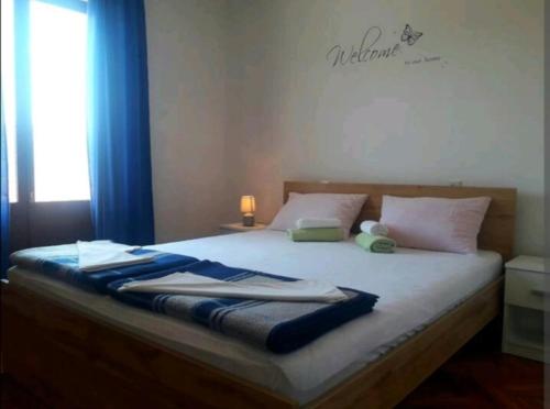 a bedroom with a bed with towels on it at Rooms Ankica in Primošten