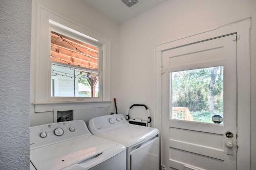 a white laundry room with a washing machine and a window at Historic Home with Yard Near St Marys Strip! in San Antonio