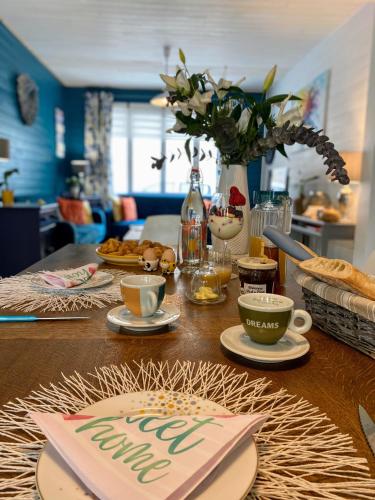une table avec des tasses et des assiettes de nourriture dans l'établissement Serendipity Eymet B&B, à Eymet