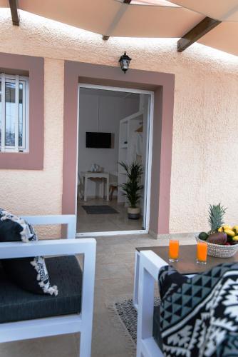 a patio with a table and chairs and a room at Le Palme in Malia