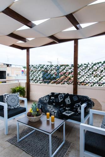 a living room with a couch and a table at Le Palme in Malia
