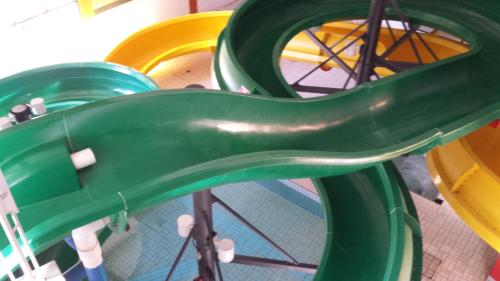 a green slide in a playground with a green slide at Douglas Fir Resort & Chalets in Banff