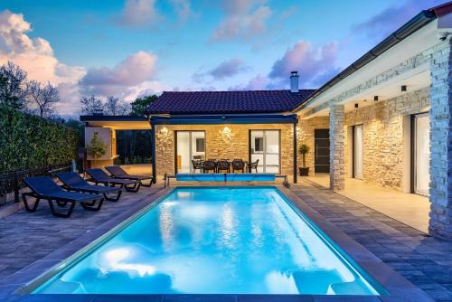 a swimming pool in the backyard of a house at Villa Larra in Gostinjac
