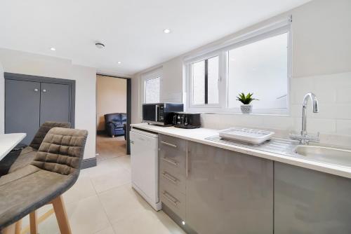 a kitchen with a sink and a counter top at Magee Town House 'Sleeping 8 guests' in Londonderry County Borough