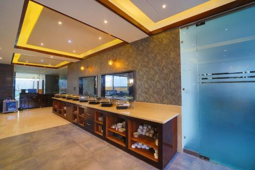 a large room with a counter with food on it at Hotel Holy Vivasa in Rishīkesh
