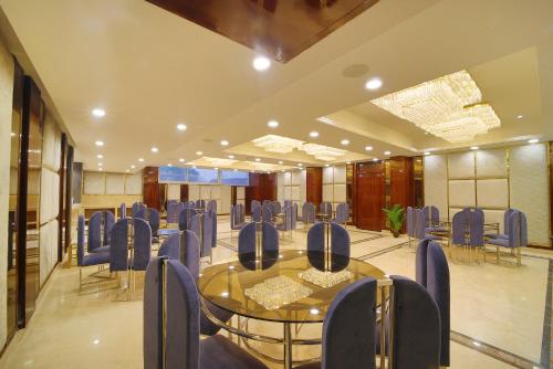 a conference room with a glass table and chairs at Hotel Holy Vivasa in Rishīkesh
