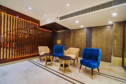 a meeting room with blue chairs and a table at Hotel Holy Vivasa in Rishīkesh